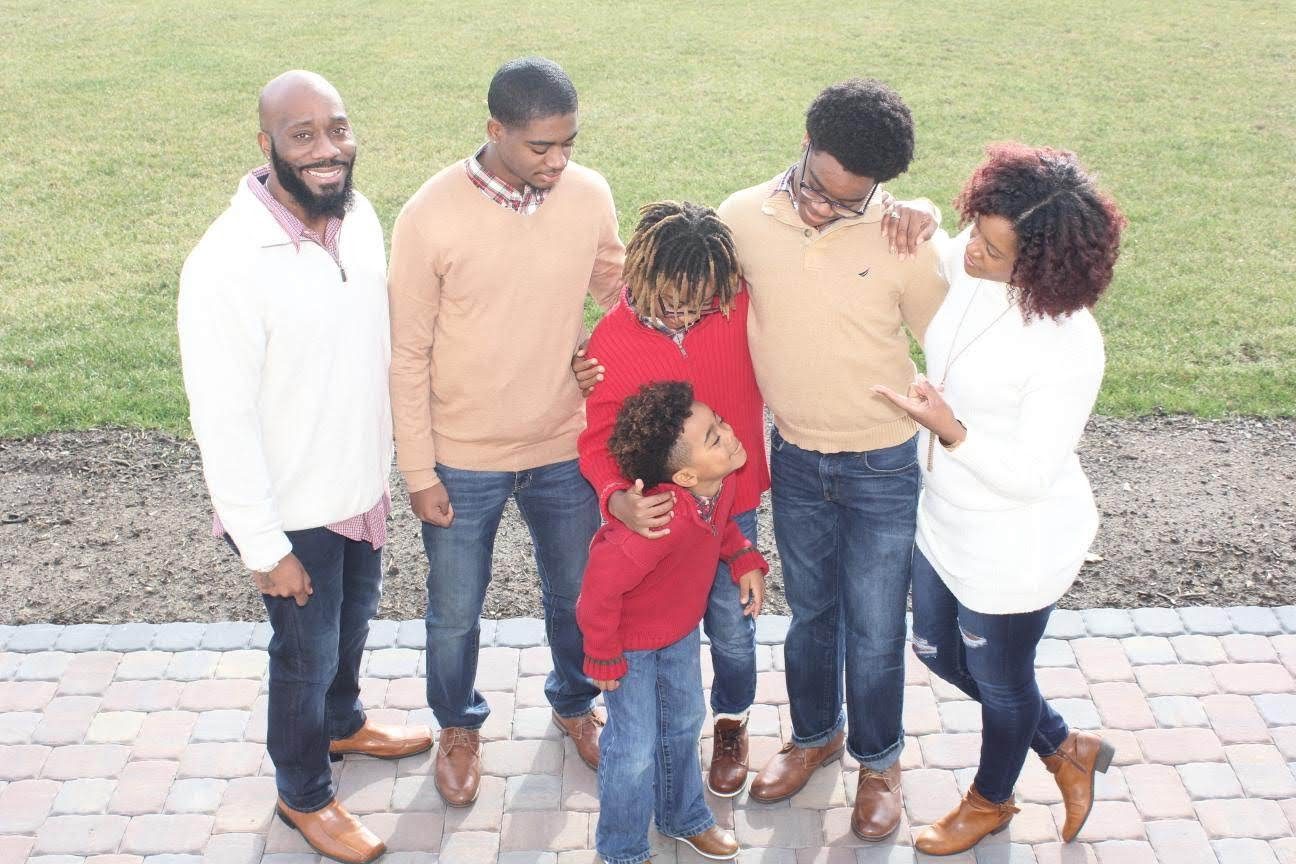 Mother, father, and four sons enjoying each others company