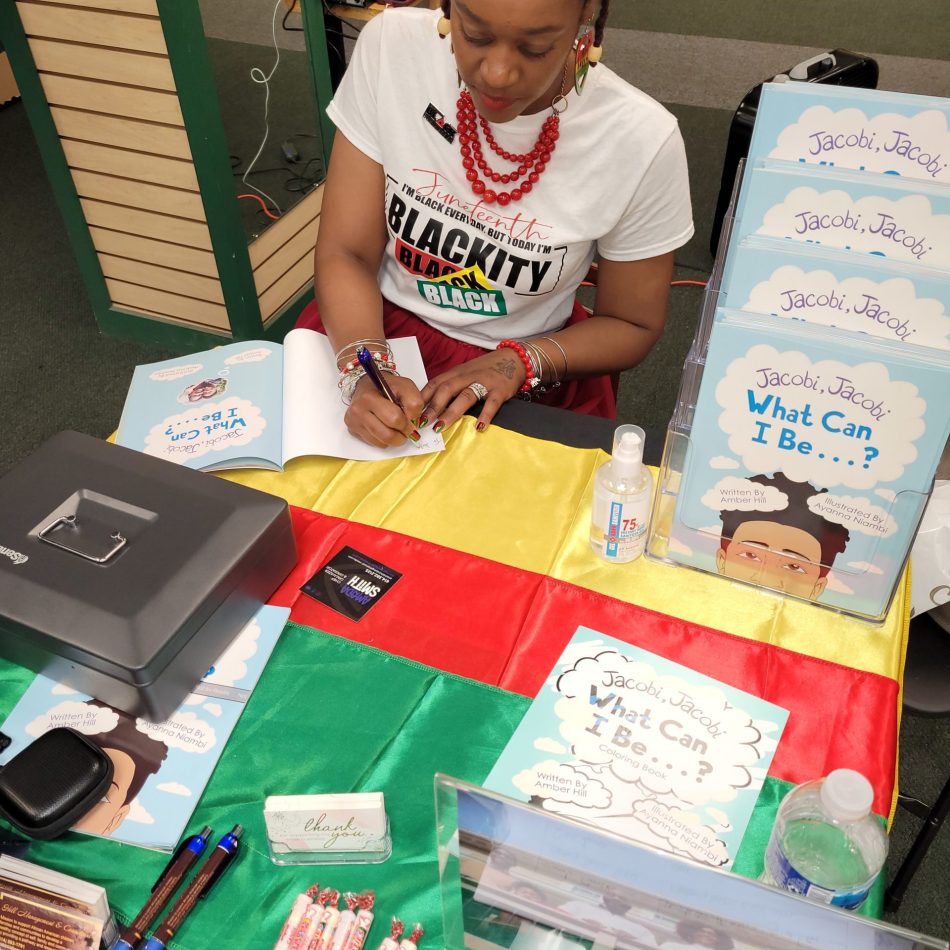African American author signing a book