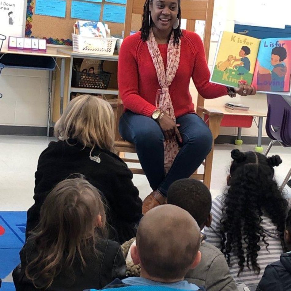 African American author reading her children's book to a classroom